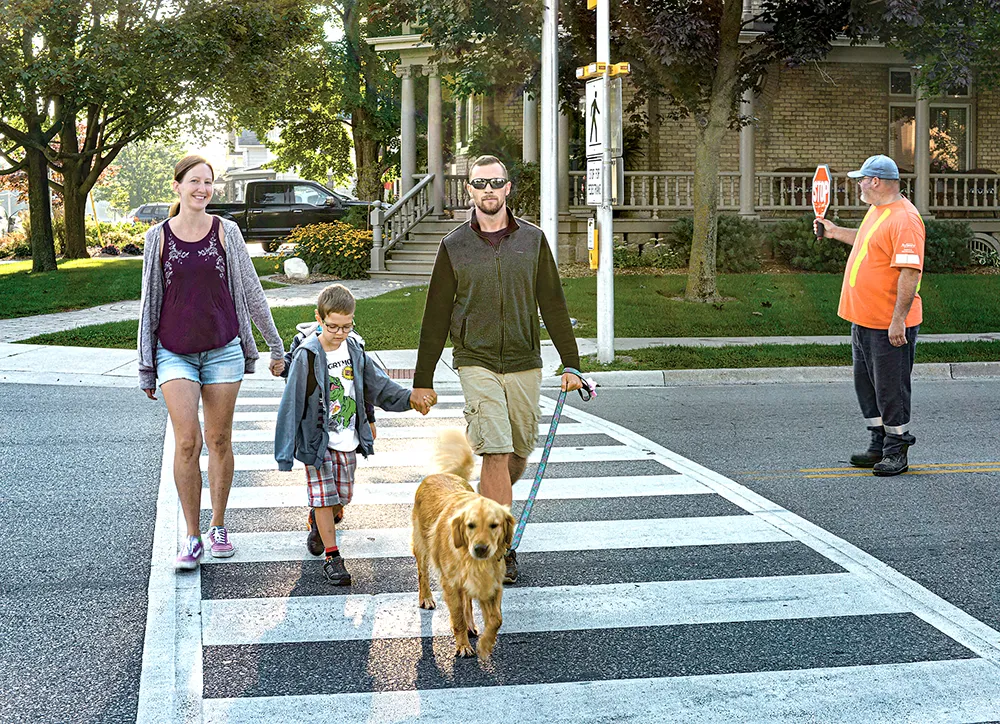 Alymer family crosses street in Alymer Ontario